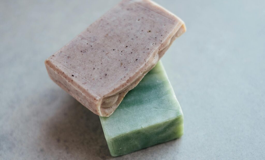 Close-up of two organic handmade soap bars, showcasing natural textures and colors.