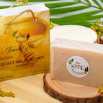 Elegant display of handmade goat milk soap with honey, surrounded by natural elements for an organic appeal.
