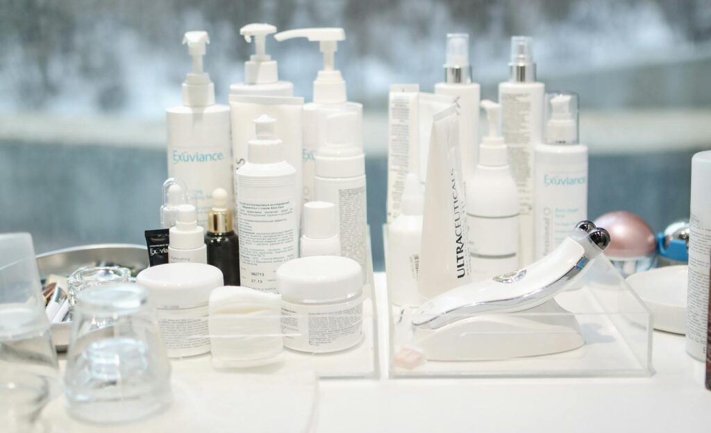 Skincare products arranged on a table by a window with a city view in the background.