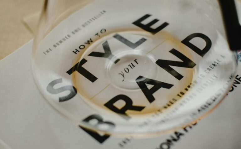 A coffee pot rests atop a book titled 'How to Style Your Brand', capturing the essence of creative branding.